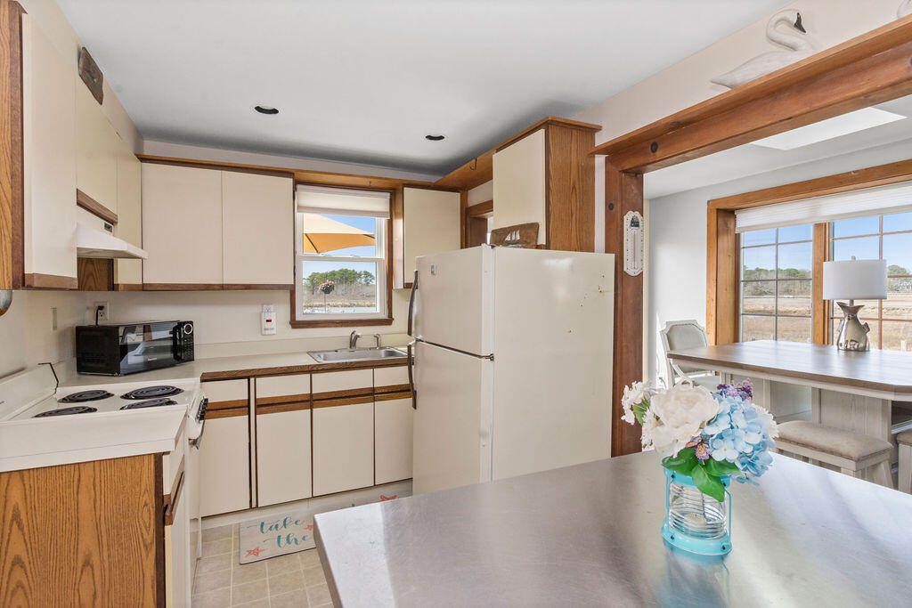 14 Lower County Road Dennis Port, MA 02639 - Photo 22 of 56 a kitchen with stainless steel appliances a refrigerator sink and cabinets