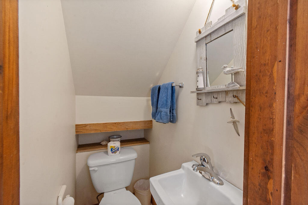 14 Lower County Road Dennis Port, MA 02639 - Photo 26 of 56 a bathroom with a sink mirror and toilet