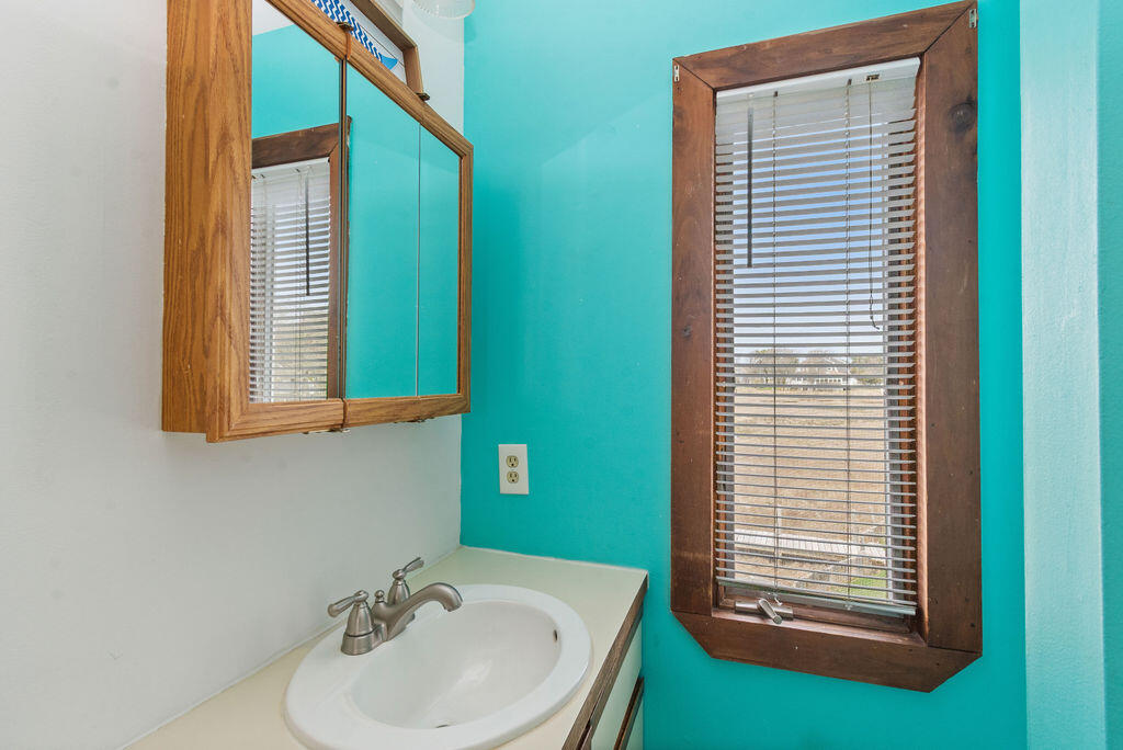 14 Lower County Road Dennis Port, MA 02639 - Photo 34 of 56 a bathroom with a sink a mirror and a window