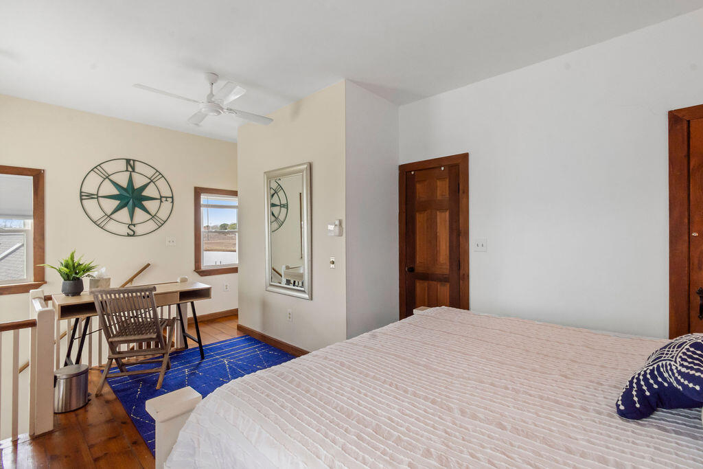 14 Lower County Road Dennis Port, MA 02639 - Photo 36 of 56 a bedroom with a bed and wooden floor