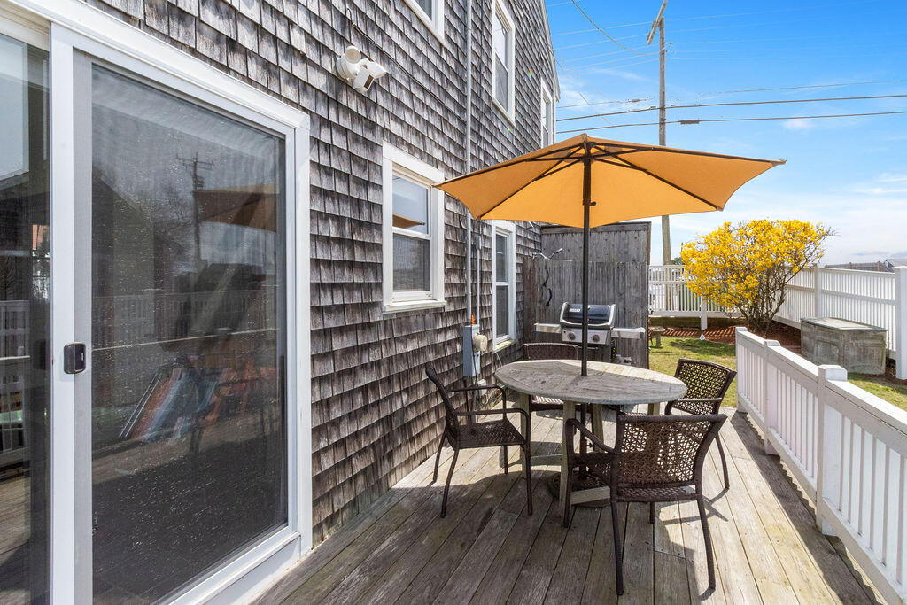 14 Lower County Road Dennis Port, MA 02639 - Photo 45 of 56 a view of balcony with a table and chairs under an umbrella