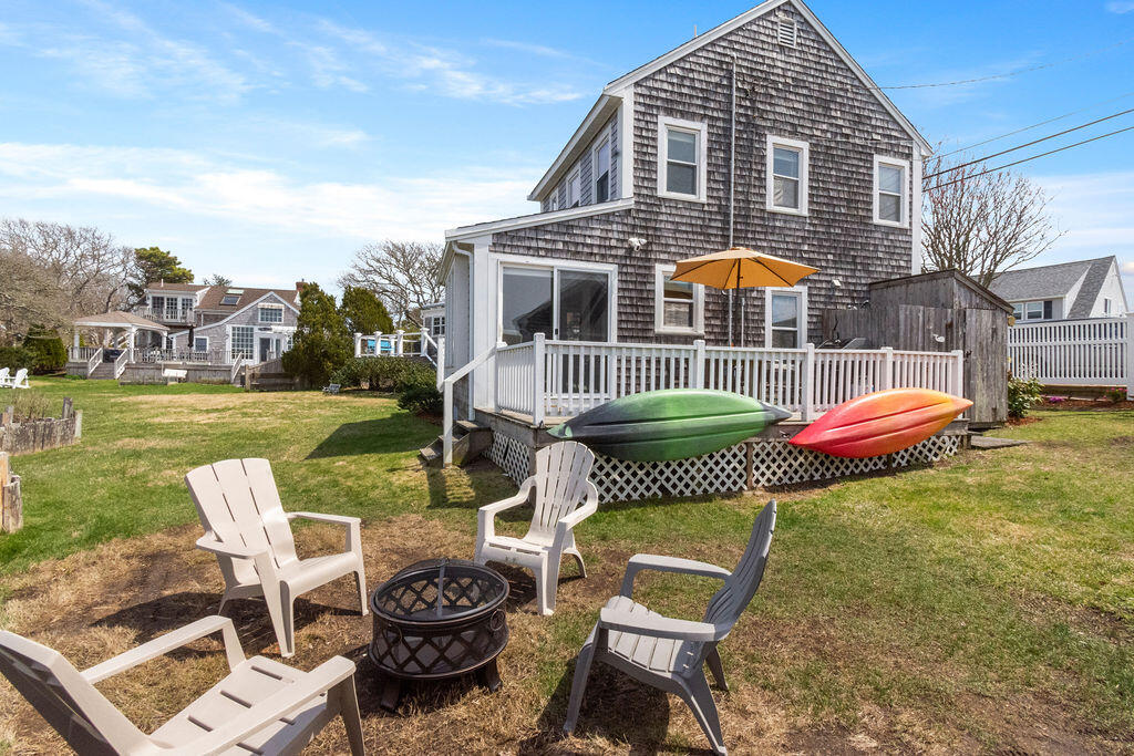14 Lower County Road Dennis Port, MA 02639 - Photo 51 of 56 a front view of a house with garden and furniture