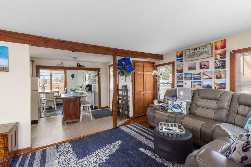 14 Lower County Road Dennis Port, MA 02639 - Photo 9 of 56 a living room with furniture and a book shelf