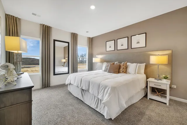 a bedroom with a large bed and a window