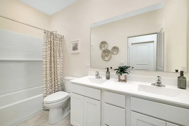 a bathroom with a toilet a sink and a large mirror