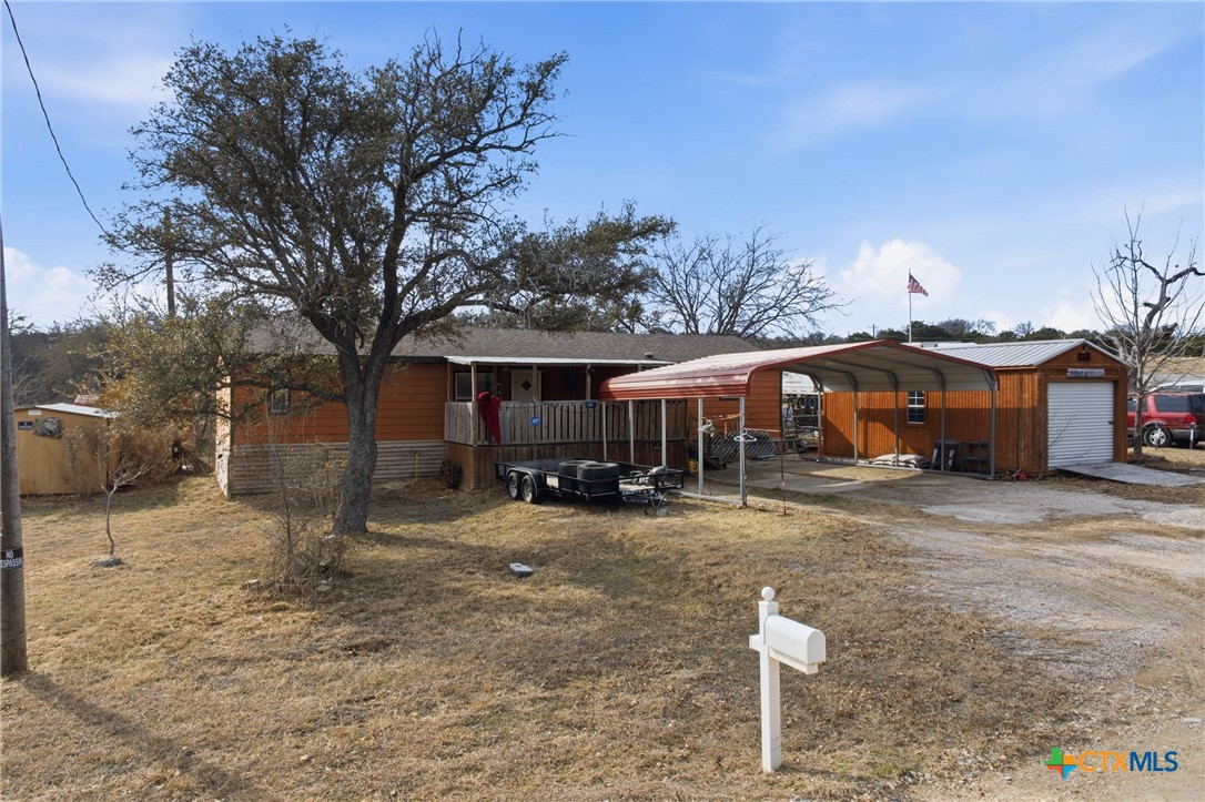 164 County Road 4450 Kempner, TX 76539 - Photo 11 of 42 a front view of a house with a yard covered with trees