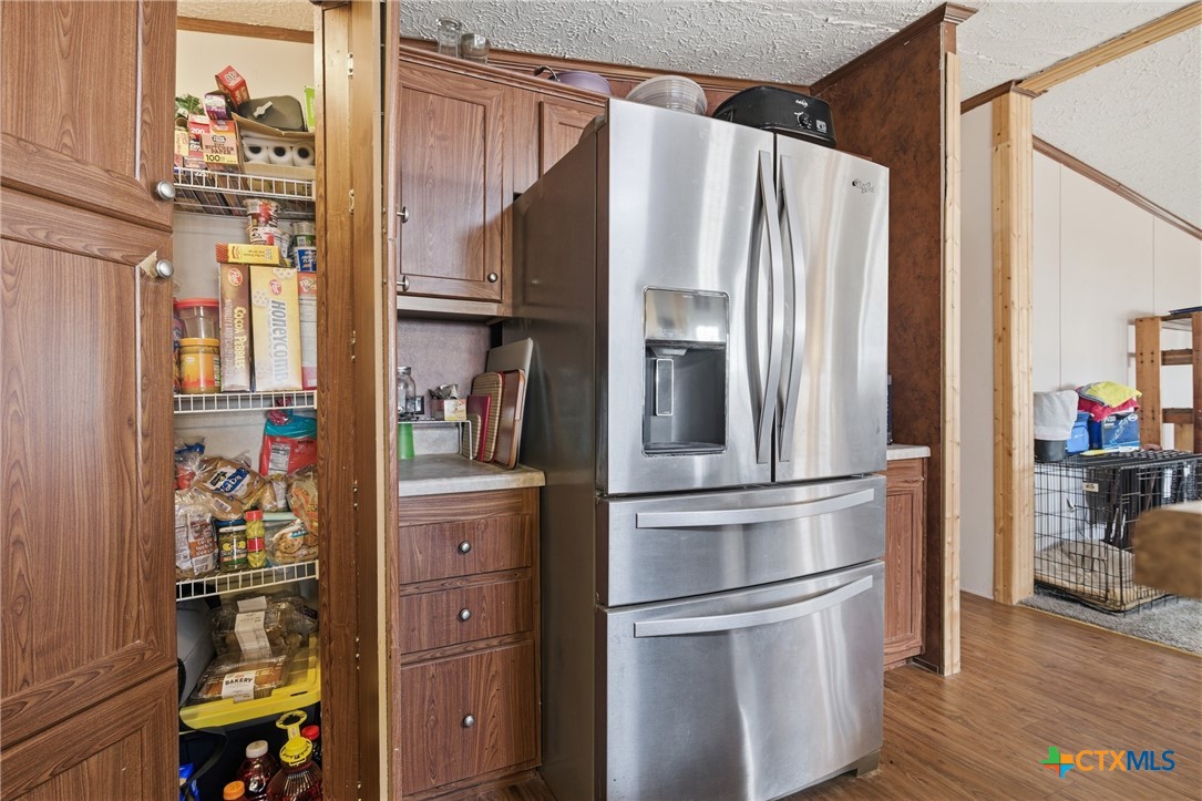 164 County Road 4450 Kempner, TX 76539 - Photo 25 of 42 a kitchen with stainless steel appliances a refrigerator and cabinets