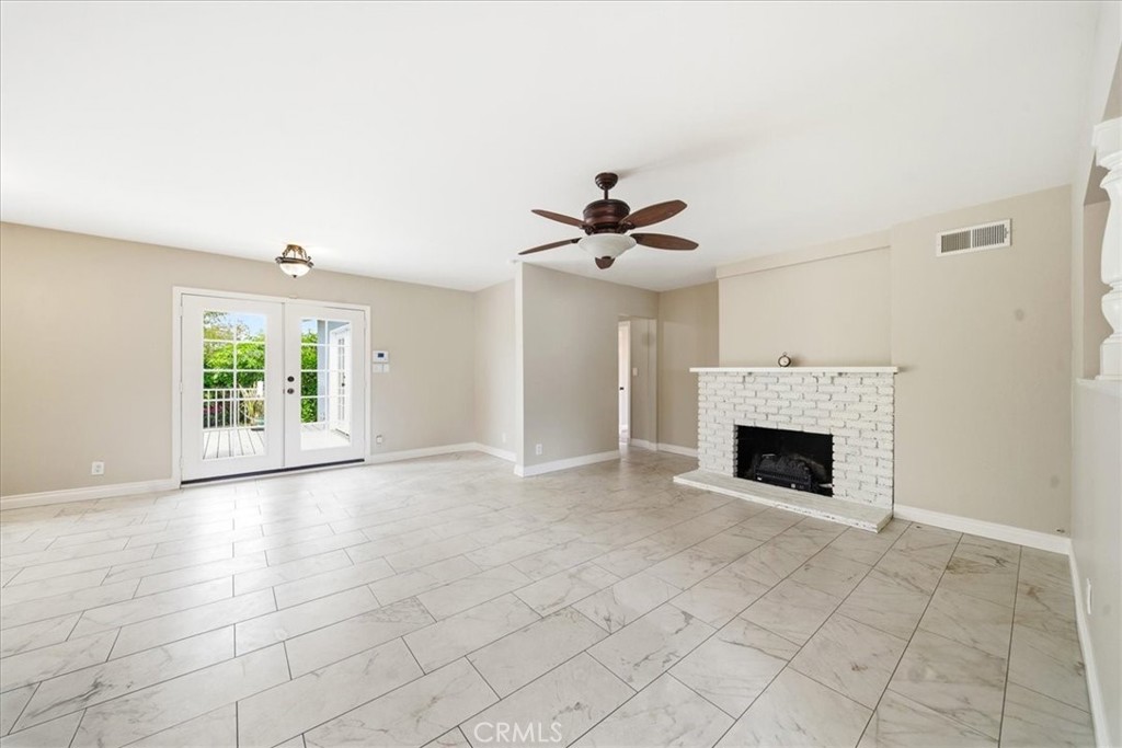 6481 Dos Rios Road Downey, CA 90240 - Photo 20 of 27 a view of an empty room with a fireplace and a window