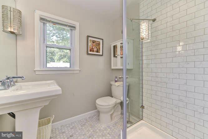 7923 Fairfax Road Alexandria, VA 22308 - Photo 21 of 29 a bathroom with a sink a toilet and shower