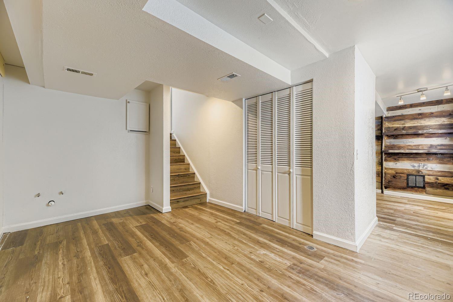 13073 South Stuart Way Parker, CO 80134 - Photo 13 of 23 a view of a room with wooden floor and stairs