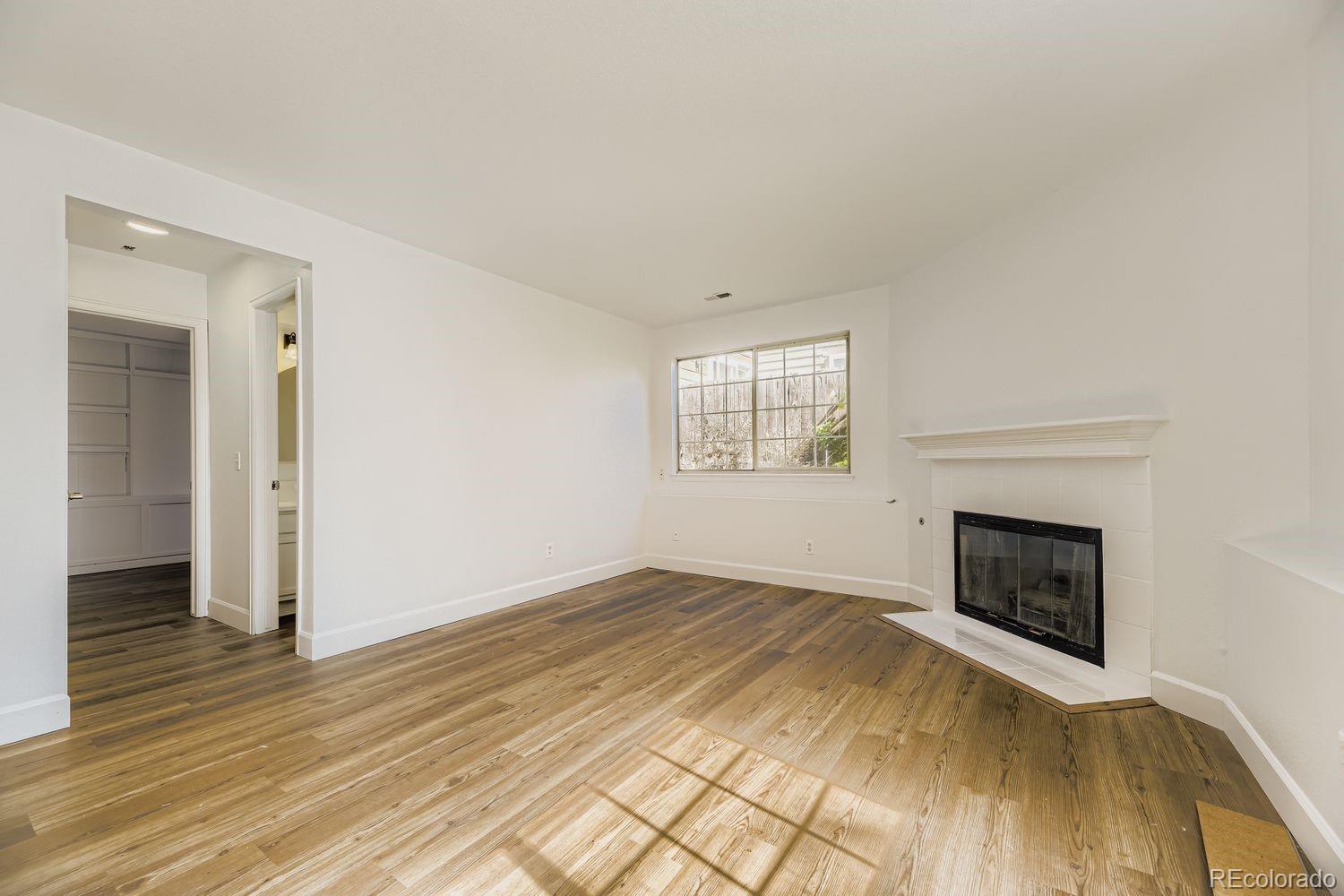 13073 South Stuart Way Parker, CO 80134 - Photo 16 of 23 an empty room with windows and fireplace