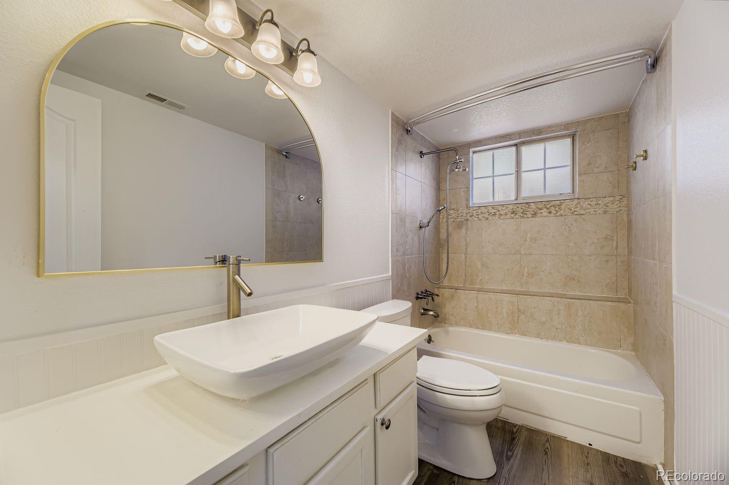 13073 South Stuart Way Parker, CO 80134 - Photo 18 of 23 a bathroom with a sink a toilet and shower