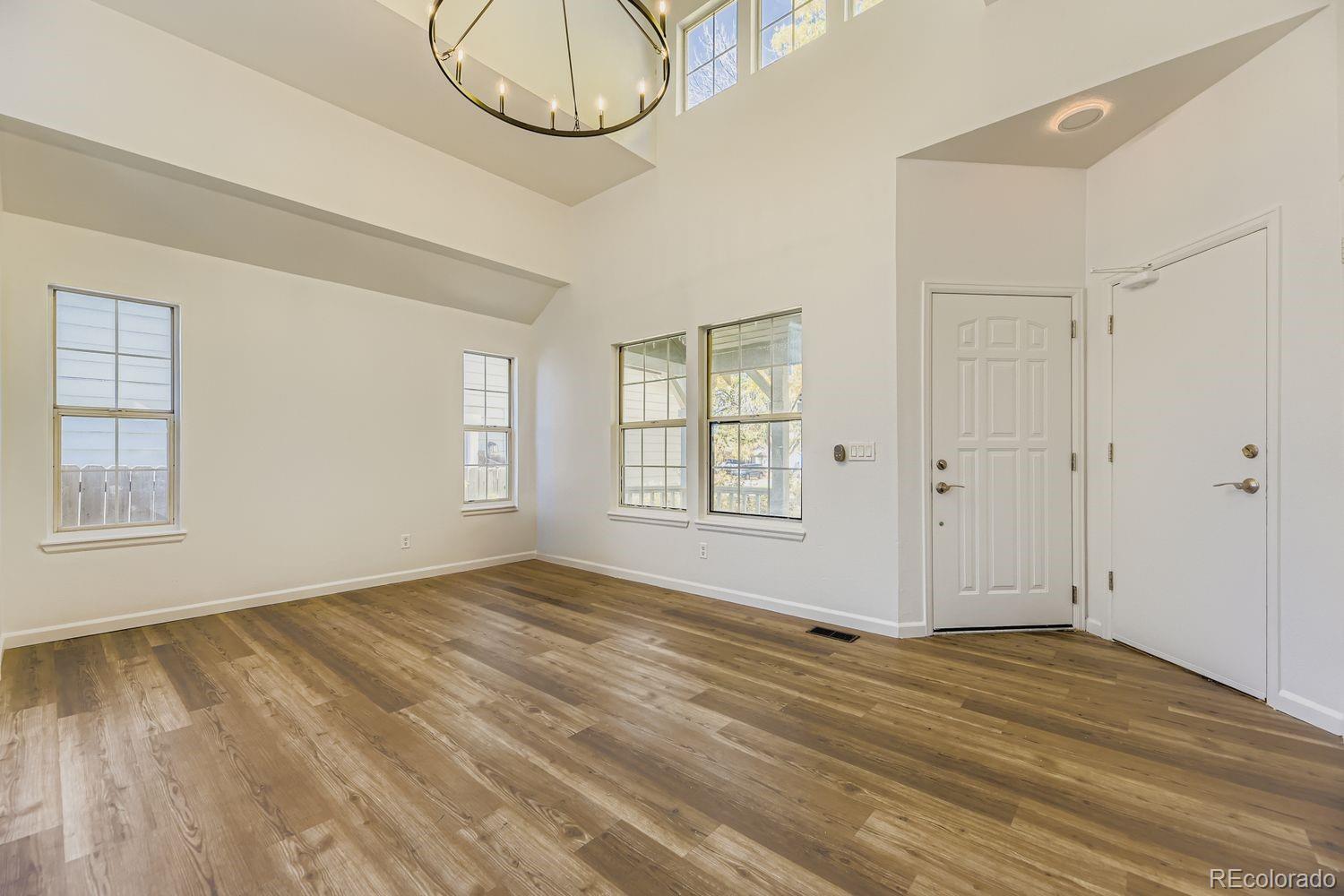 13073 South Stuart Way Parker, CO 80134 - Photo 3 of 23 a view of empty room with wooden floor and fan