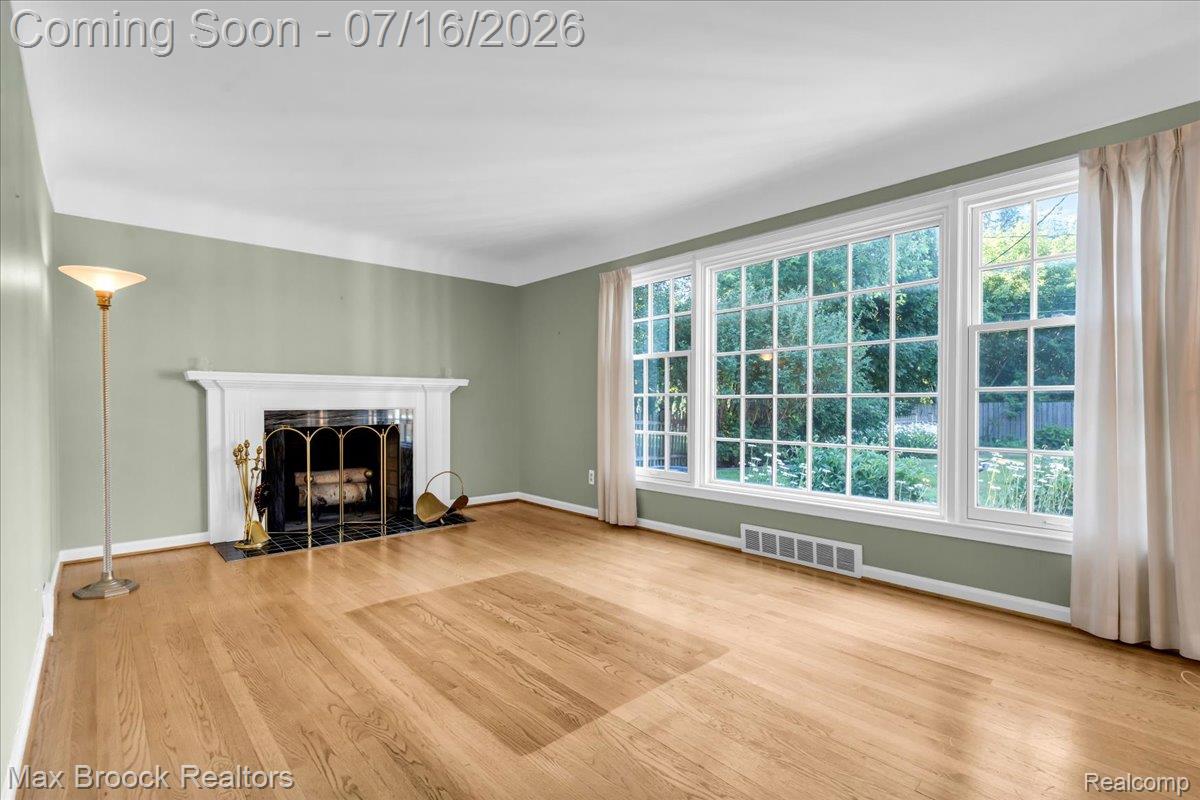 1292 Yorkshire Road Birmingham, MI 48009 - Photo 6 of 47 Light wood-finish flooring complements the broad window array