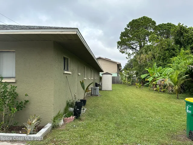 a backyard of a house with table and chairs