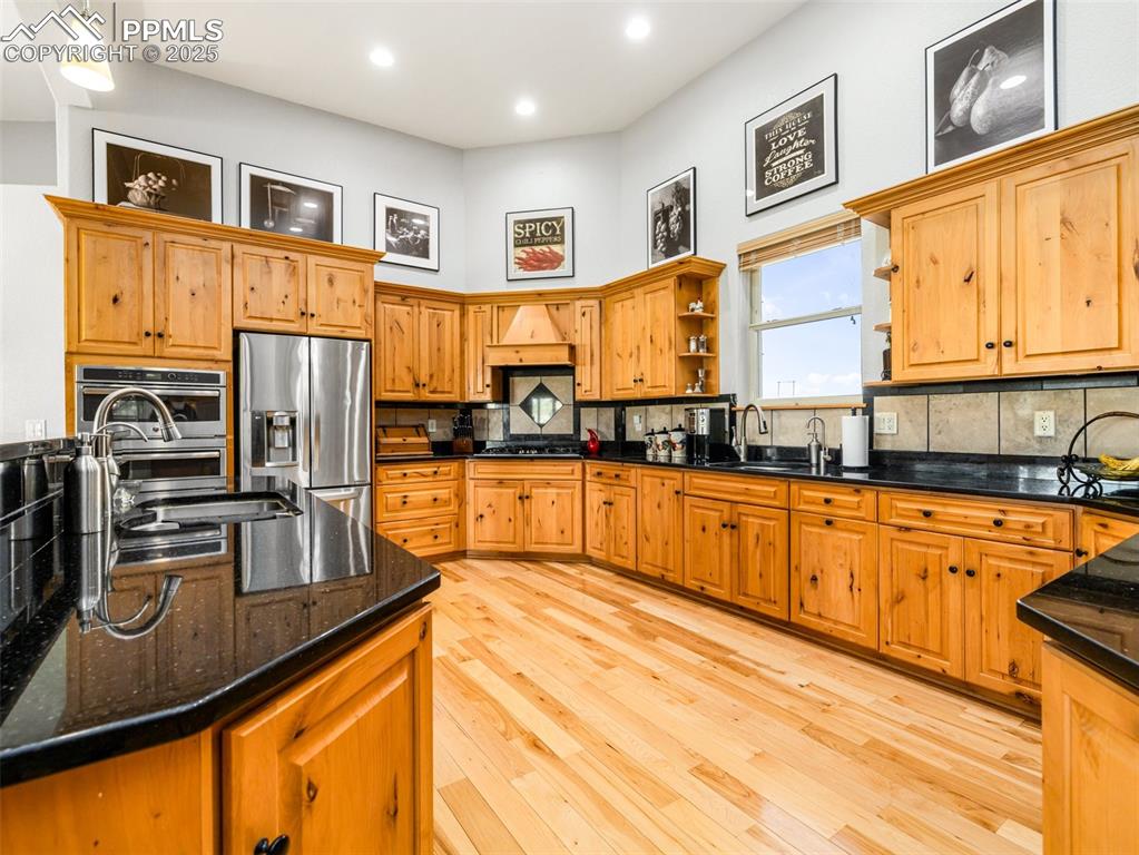 Undisclosed Address Colorado City, CO 81019 - Photo 10 of 46 a kitchen with stainless steel appliances granite countertop a stove top oven a sink dishwasher a refrigerator and cabinets with wooden floor