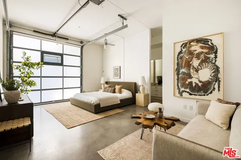 a bedroom with furniture and a window