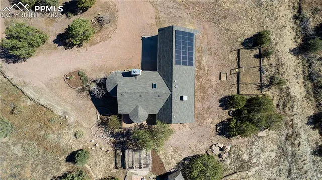 an aerial view of a house with a yard and lake view