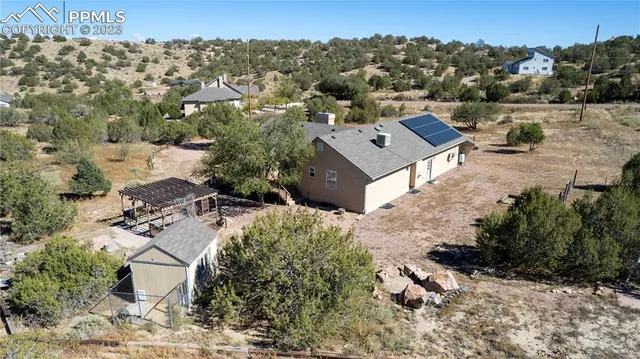 an aerial view of a house with a yard