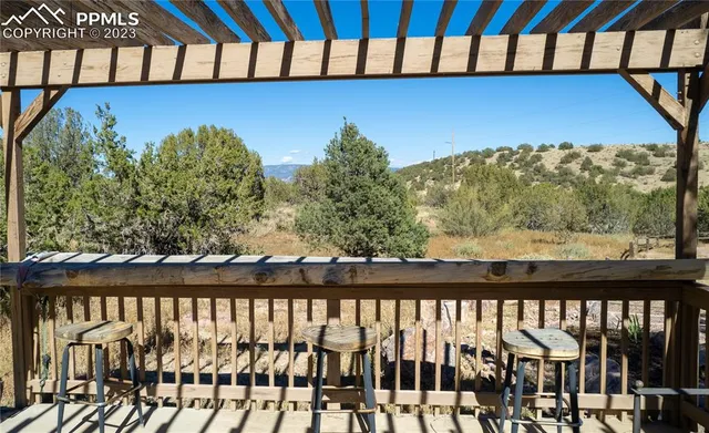 a view of a yard with wooden fence