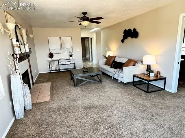 a living room with furniture and a fireplace