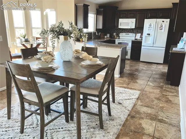 a view of a kitchen with kitchen island and wooden floor