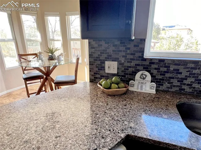 a view of a dining room with furniture and windows