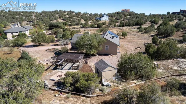 an aerial view of a house with a yard