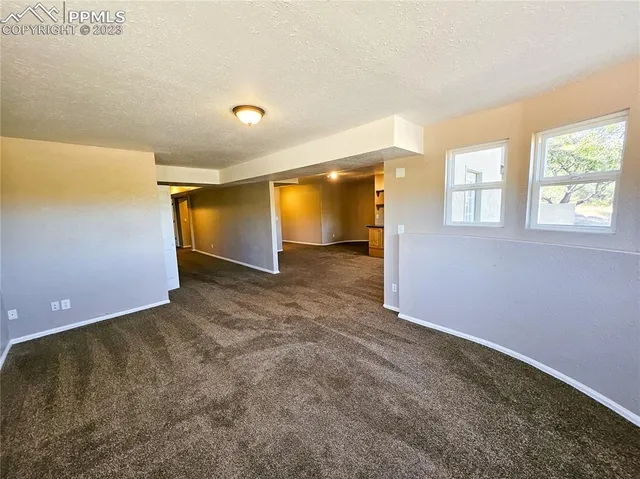 an empty room with a empty space and windows