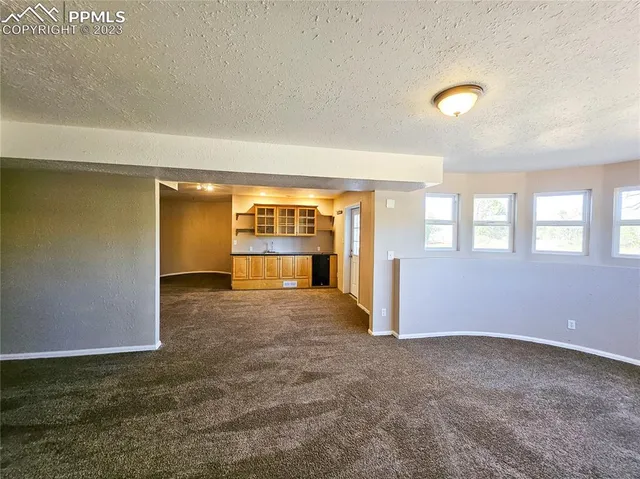 a view of an empty room with a fireplace