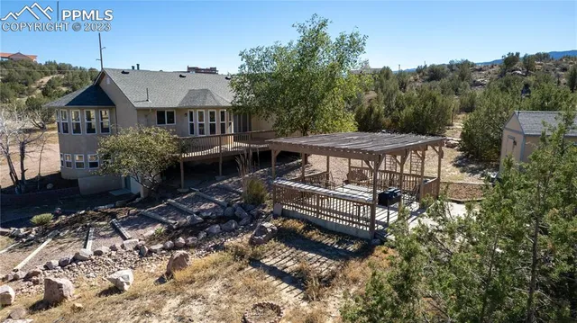 a view of a house with backyard and sitting area