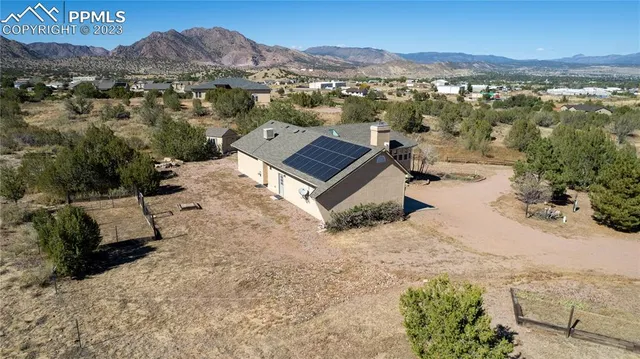 an aerial view of a house with a yard