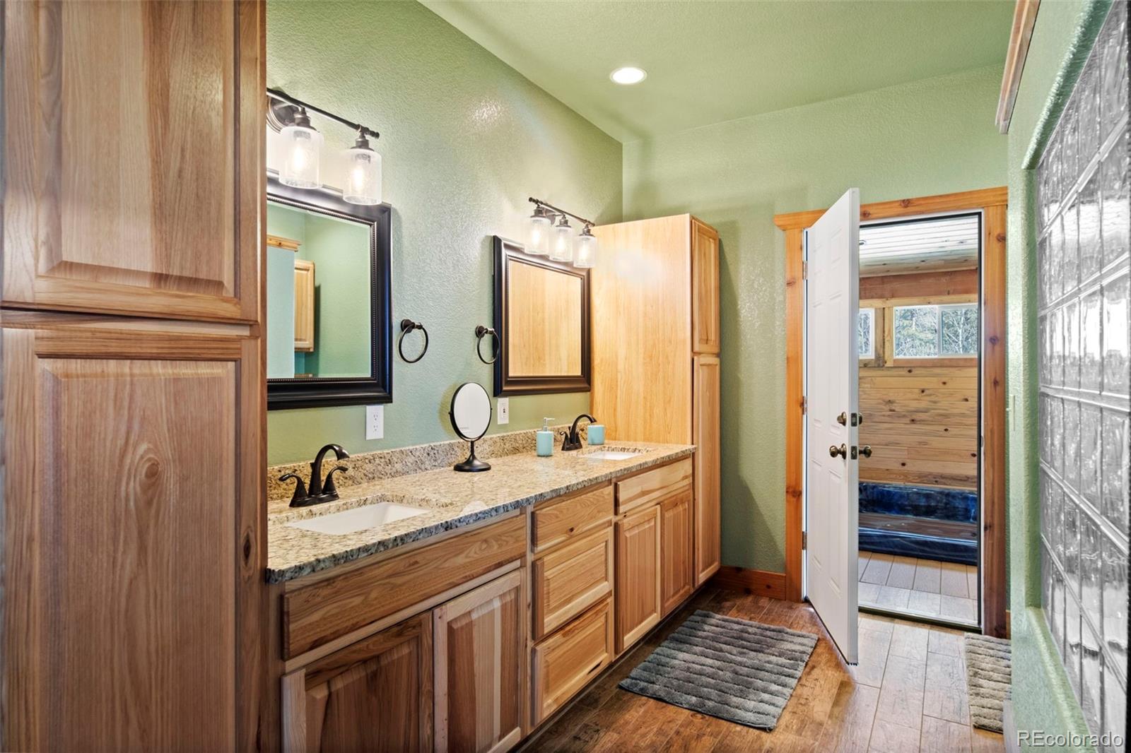 412 Evergreen Road Black Hawk, CO 80422 - Photo 24 of 48 a spacious bathroom with double vanity and a mirror