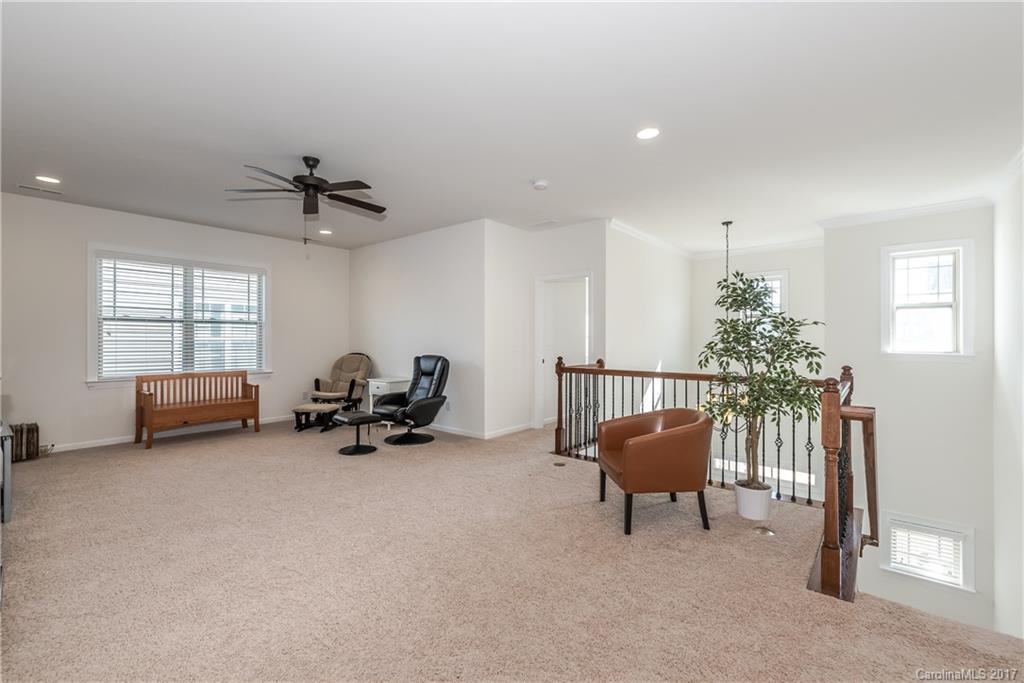 541 Brookhaven Drive, Unit 76 Fort Mill, SC 29708 - Photo 15 of 24 a living room with furniture and a chandelier