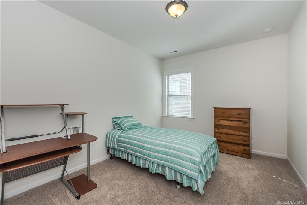 541 Brookhaven Drive, Unit 76 Fort Mill, SC 29708 - Photo 20 of 24 a bedroom with a bed and a dresser
