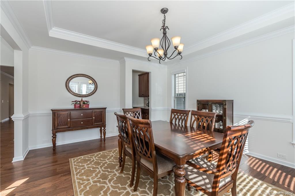 541 Brookhaven Drive, Unit 76 Fort Mill, SC 29708 - Photo 4 of 24 a view of a dining room with furniture and chandelier