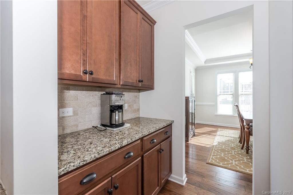 541 Brookhaven Drive, Unit 76 Fort Mill, SC 29708 - Photo 5 of 24 a kitchen with granite countertop wooden cabinets and a counter top space