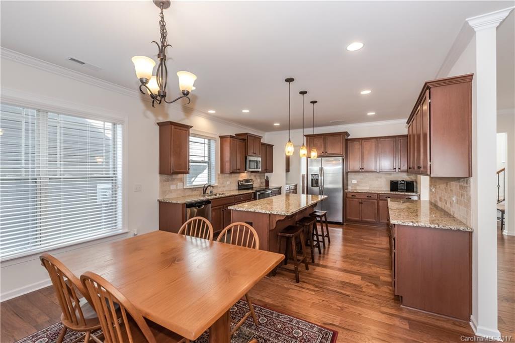 541 Brookhaven Drive, Unit 76 Fort Mill, SC 29708 - Photo 7 of 24 a view of a dining room with furniture window and wooden floor