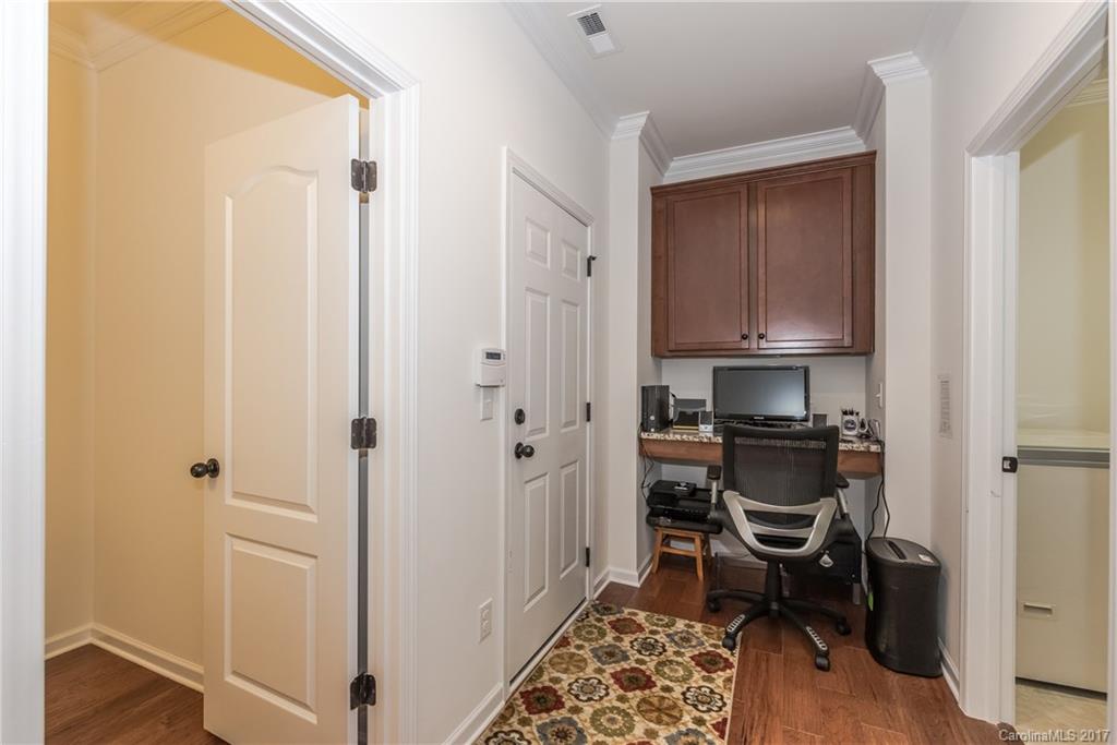 541 Brookhaven Drive, Unit 76 Fort Mill, SC 29708 - Photo 10 of 24 a view of a workspace with wooden floor and chair