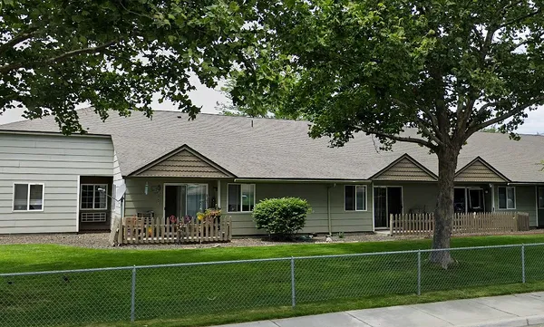 a front view of a house with a yard table and chairs