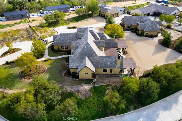 an aerial view of residential houses with outdoor space and parking