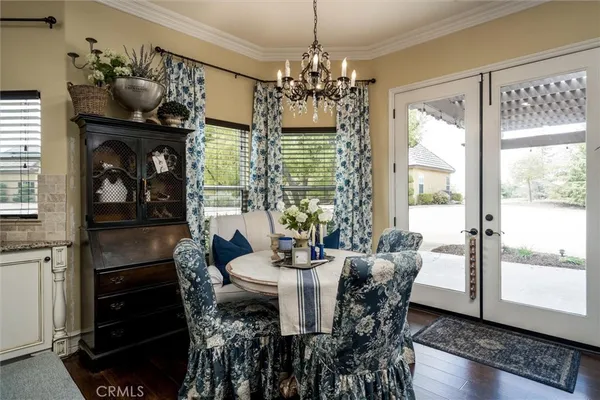 a spacious bedroom with bed and a chandelier