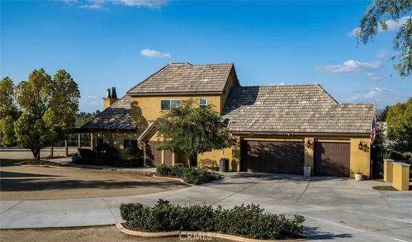 a kitchen with stainless steel appliances granite countertop a refrigerator a sink dishwasher a stove and a dining table with wooden floor