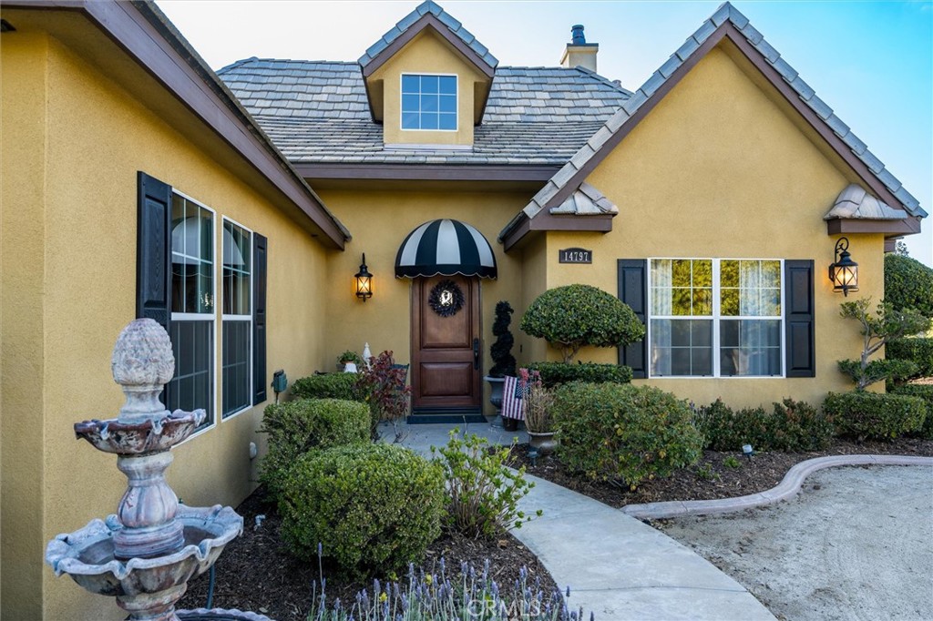 14787 Wood Road Riverside, CA 92508 - Photo 35 of 64 a front view of a house with garden