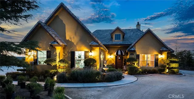 a kitchen with stainless steel appliances granite countertop a stove top oven a sink dishwasher and white cabinets with wooden floor