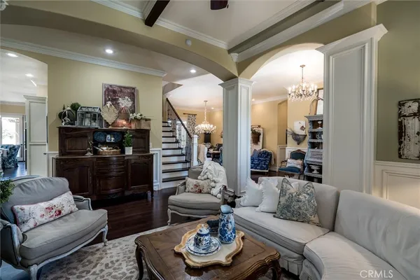 a kitchen with stainless steel appliances granite countertop a stove top oven a sink dishwasher and white cabinets with wooden floor
