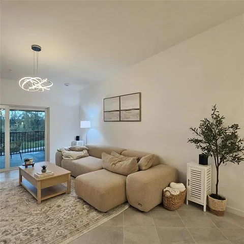 a living room with furniture and a potted plant