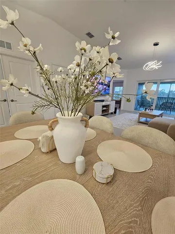 a dining room with furniture and a chandelier