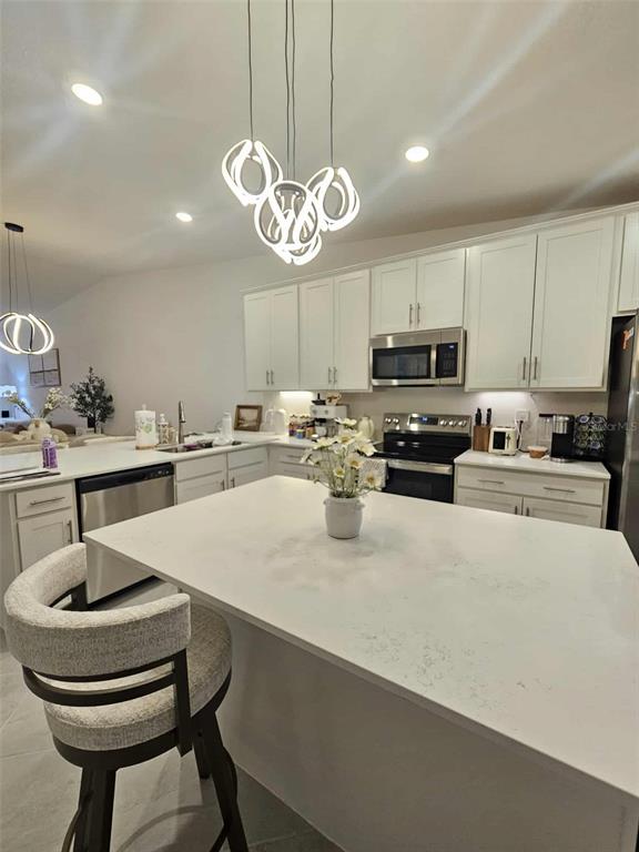 17470 Opal Sand Drive, Unit 201 Venice, FL 34293 - Photo 20 of 49 a kitchen with a refrigerator a sink and cabinets