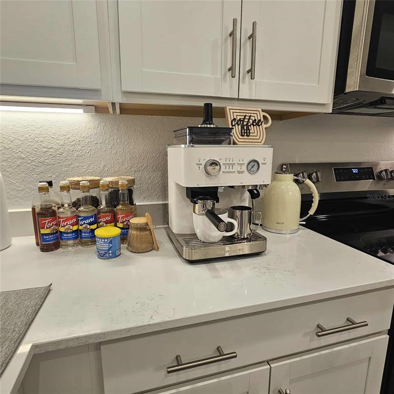17470 Opal Sand Drive, Unit 201 Venice, FL 34293 - Photo 22 of 49 a kitchen with a refrigerator and a stove